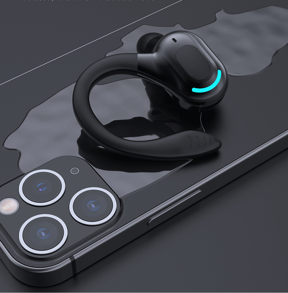 Black single-ear Bluetooth earphone resting on a dark device surface