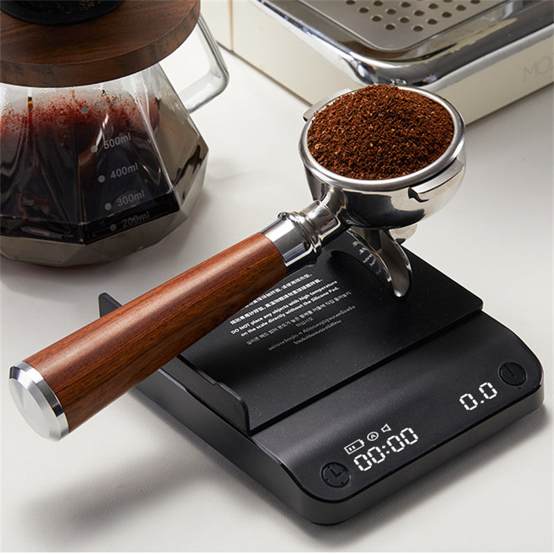 Black coffee electronic scale on counter with digital readout and textured platform