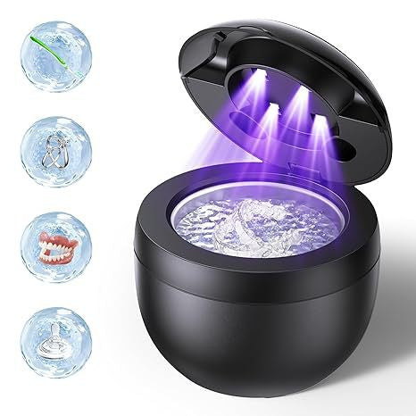 Ultrasonic denture cleaner showing lid open with purple ultrasonic light in black body