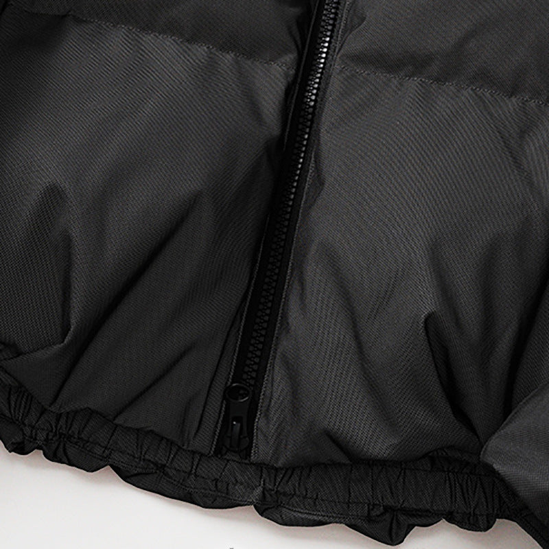 Black down jacket zipper detail with stand-collar placket and elastic hem