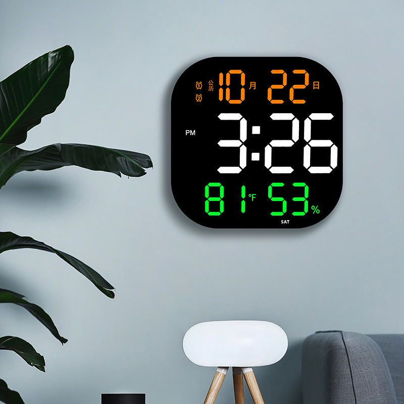 LED wall clock on wall with orange time, green °C/% indicators, and SAT label