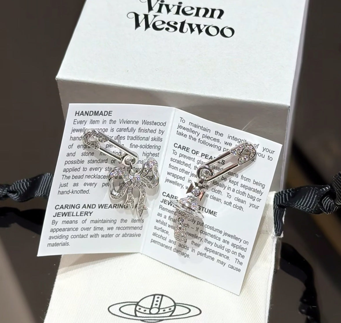 Care card and silver bow pendant necklace in Vivienne Westwood gift box