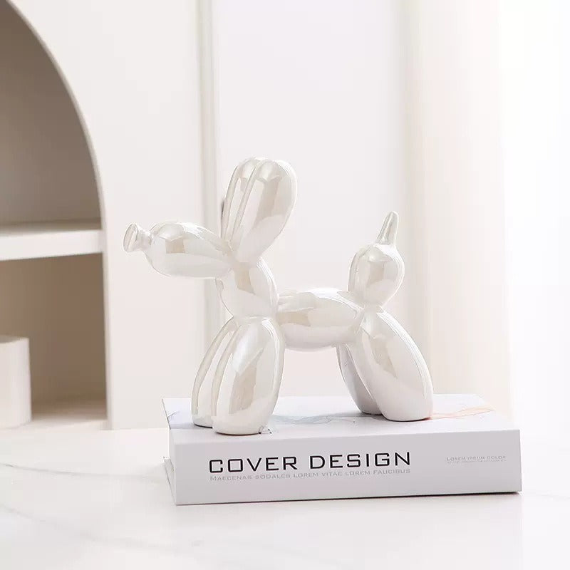 White balloon dog figurine with glossy finish on a pedestal