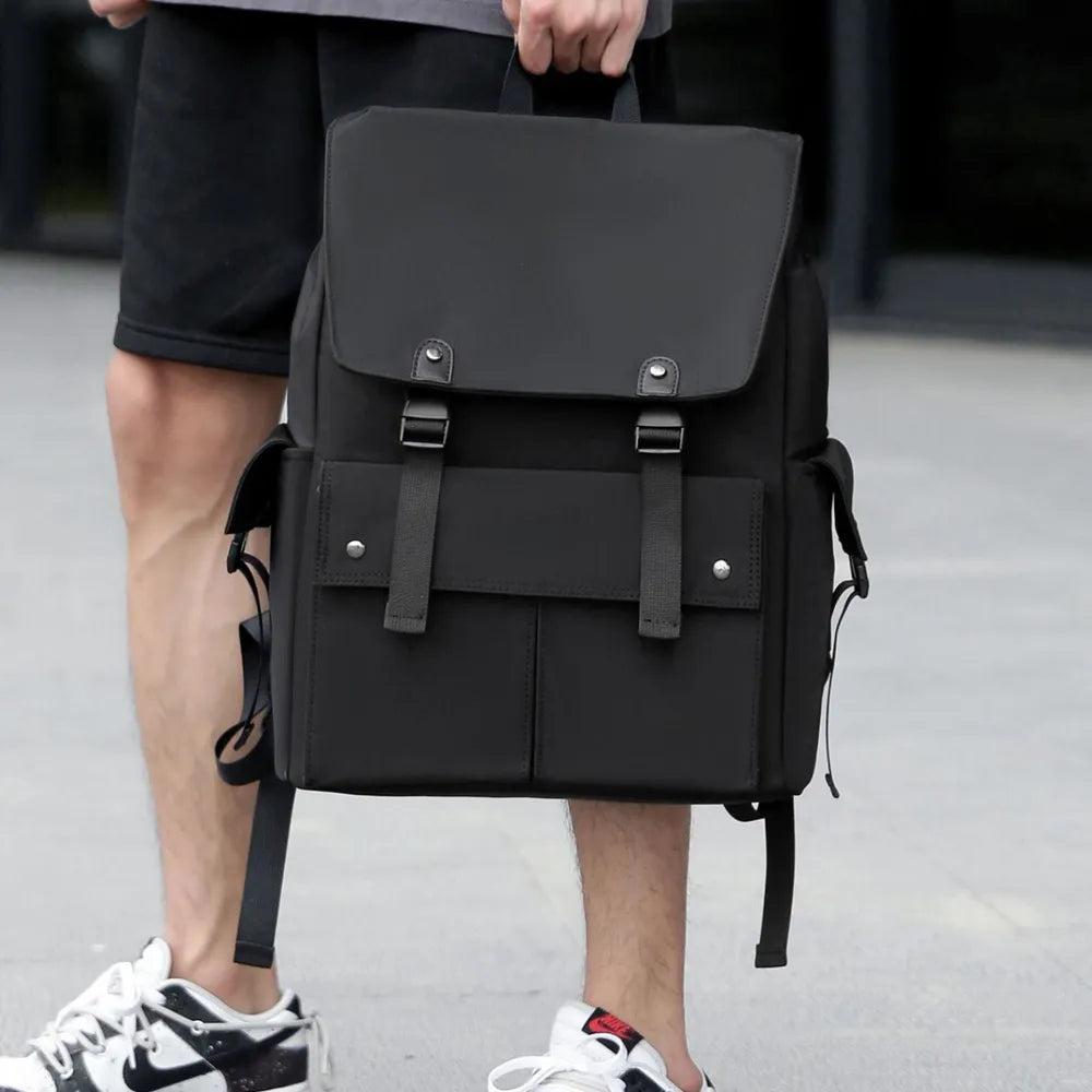 Black PU leather backpack with front flap, buckled straps, and side drawstring cords