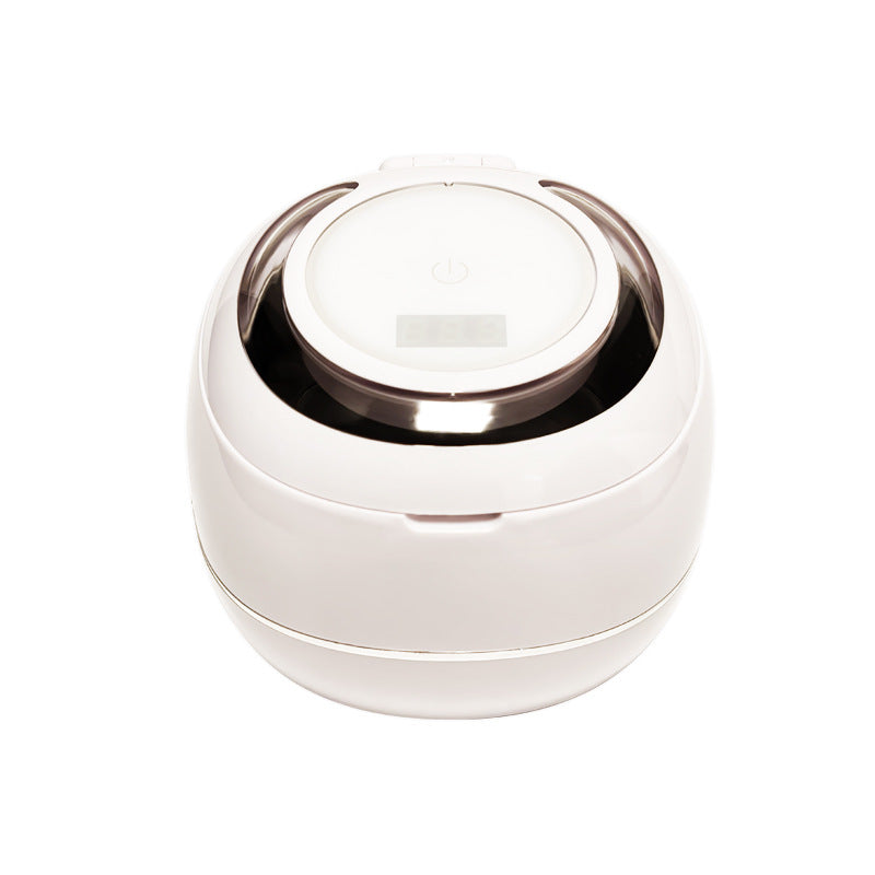 White ultrasonic denture cleaner with hinged lid and circular top control area