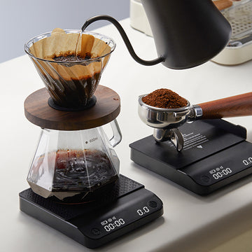Black countertop coffee electronic scale with textured platform and digital display