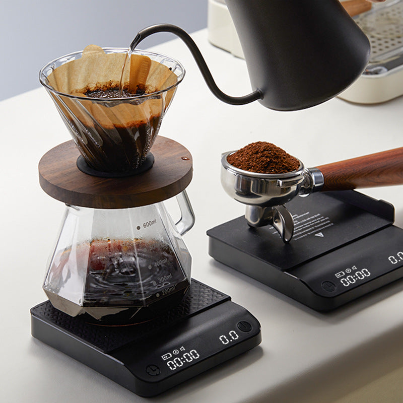 Black countertop coffee electronic scale with textured platform and digital display