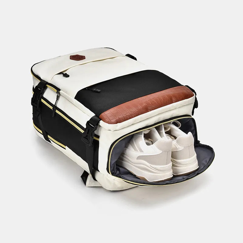 Color-block backpack bag with white front, black base, brown bottom, and front pockets