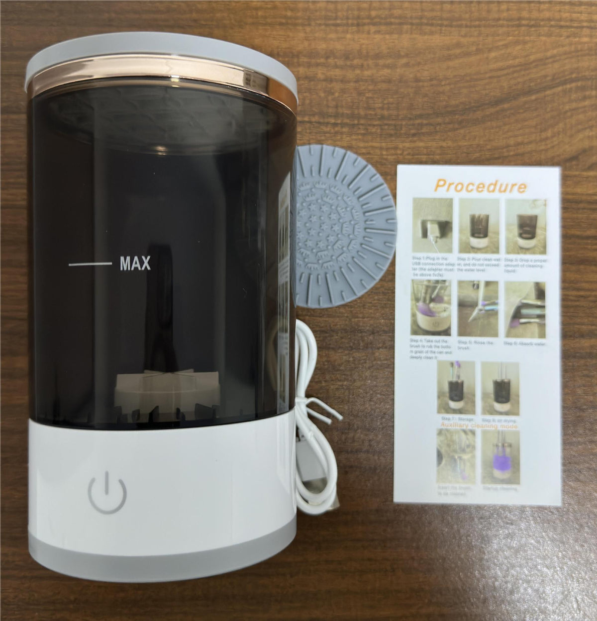 Electric makeup brush washer with dark-tinted reservoir, white base, and lid