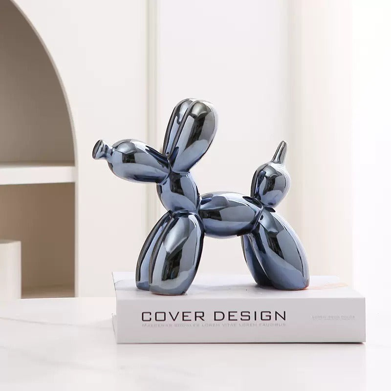 Dark silver balloon dog figurine standing on a pedestal