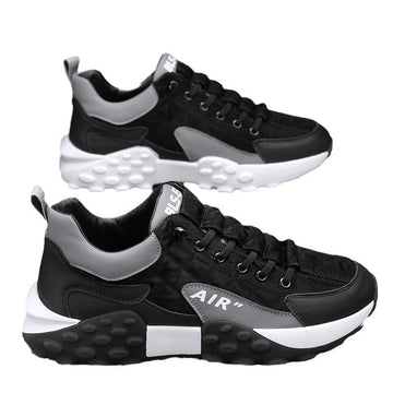 Men's black lace-up sneakers with gray accents, AIR logo, and chunky white rubber sole