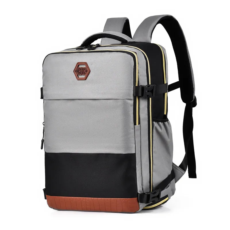 Light gray and black backpack bag with front logo patch, yellow trim, and brown bottom