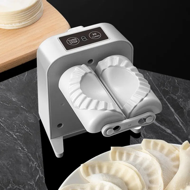 White electric dumpling maker with two-part crescent dough press and molded dumpling skins