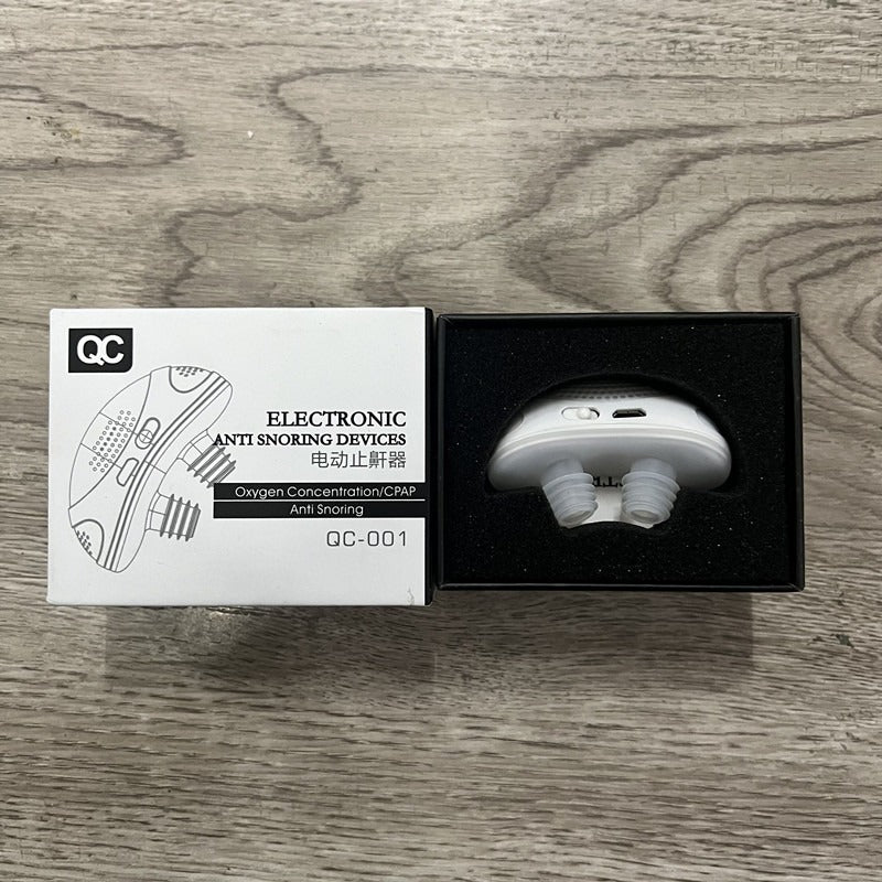 White electronic anti snoring device with mouthpiece in black presentation box.