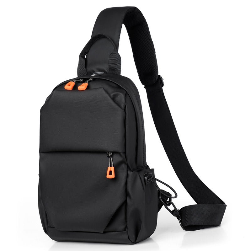 Black crossbody sling backpack bag with orange zipper pulls and adjustable shoulder strap