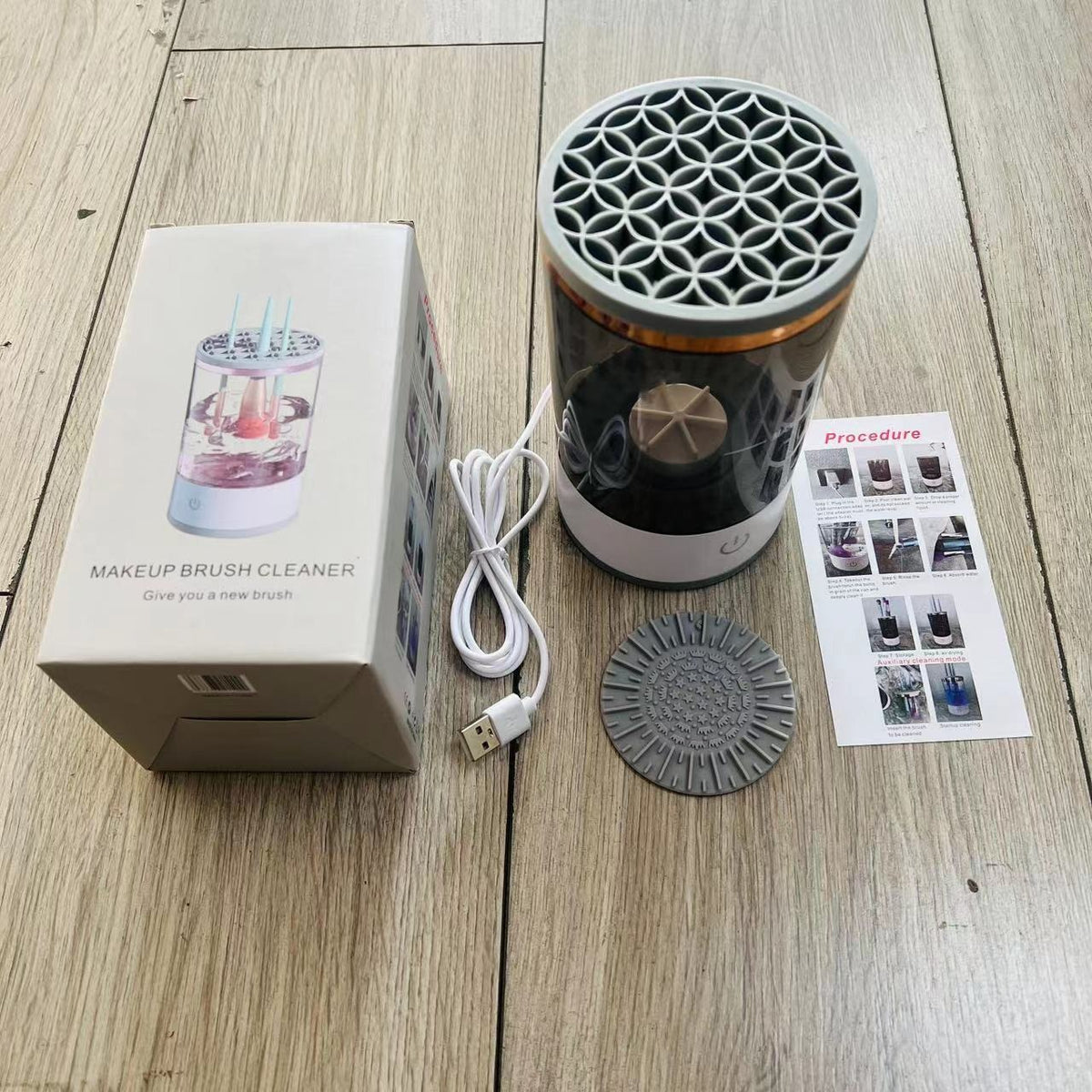 Makeup brush cleaner kit with detachable top, power cord, and instruction leaflet