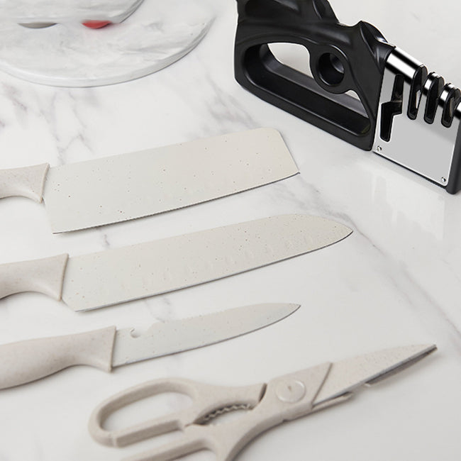 Black fixed-angle knife sharpener with handle and metal sharpening guide plate on counter