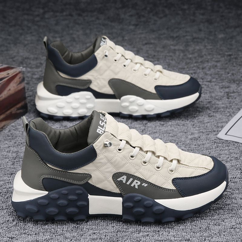 Men's cream lace-up sneakers with navy panels, AIR logo, and chunky bubble-tread sole