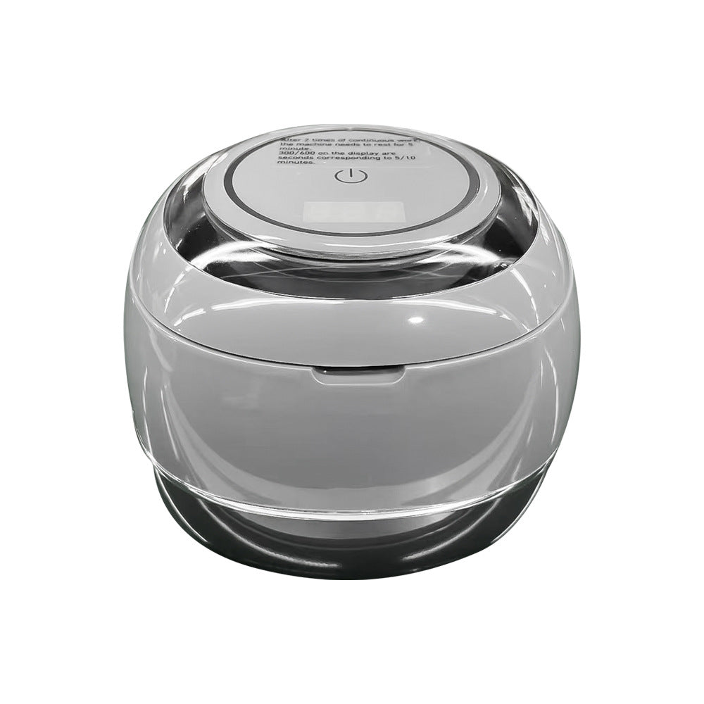 Clear-lidded ultrasonic denture cleaner base with top power symbol and smooth round shape