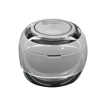 Clear-lidded ultrasonic denture cleaner base with top power symbol and smooth round shape
