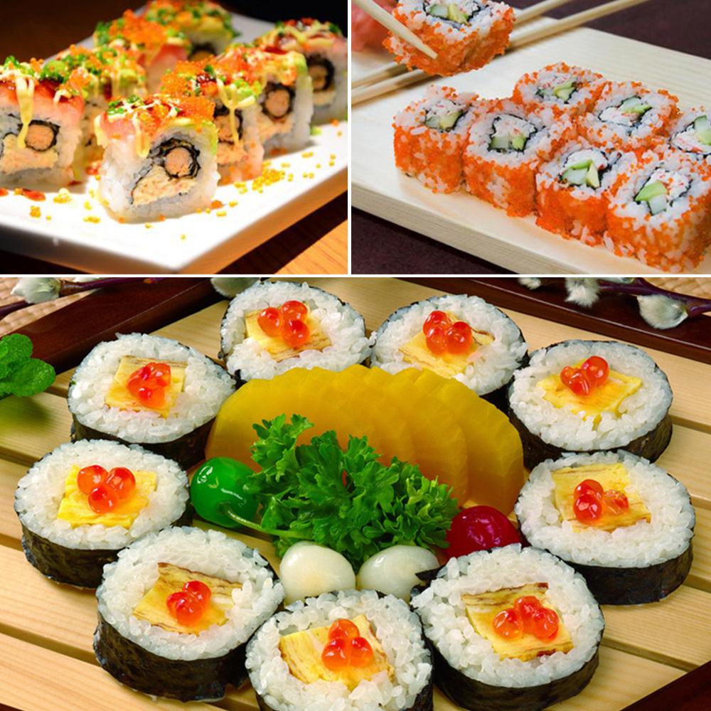 Sushi rolls with salmon and cucumber filling, topped with orange roe and sauce