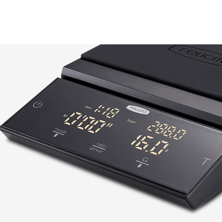 Black electronic coffee scale with backlit LCD showing weight and mode readouts