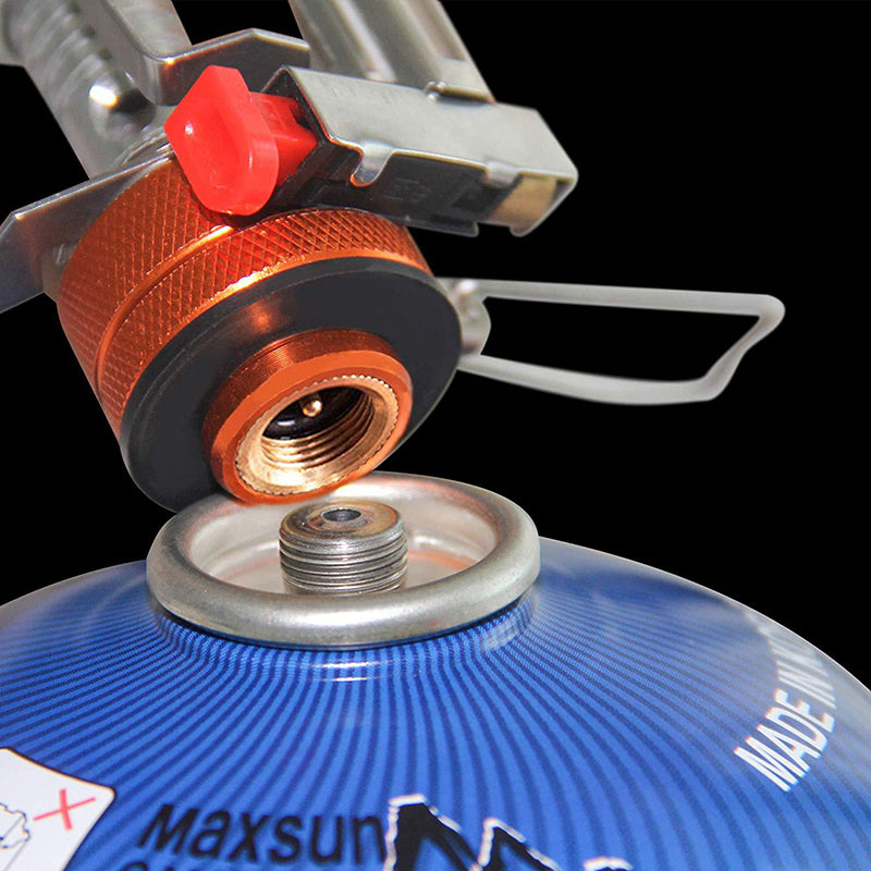 Portable mini camping stove close-up of orange control knob and burner fuel opening
