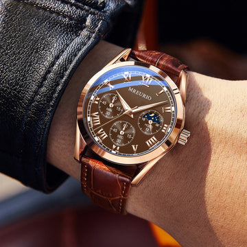 Men's quartz watch on wrist with brown leather strap and dark dial with subdials
