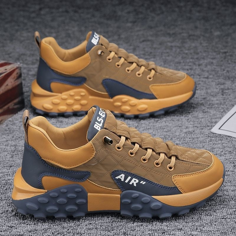 Men's tan lace-up sneakers with blue side panel, AIR logo, and chunky bubble-tread sole