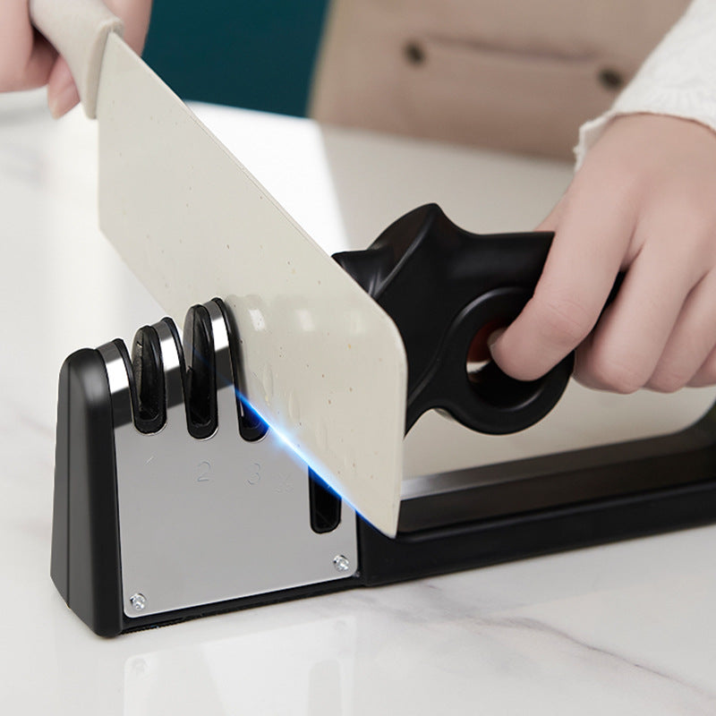 Fixed-angle knife sharpener holding a large knife blade on a black base