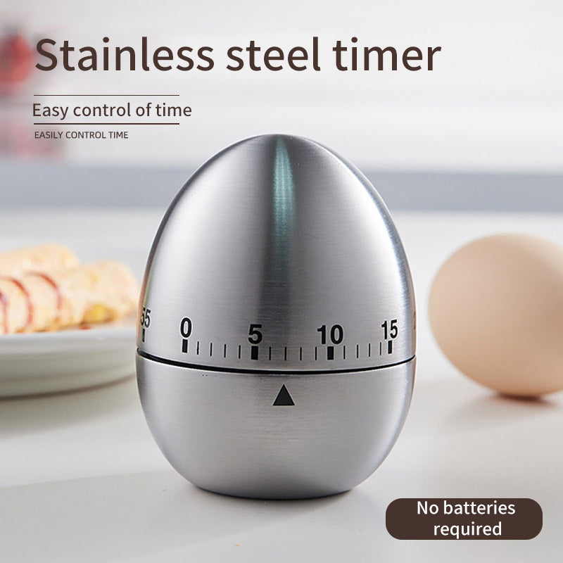 Stainless steel egg timer on countertop, dial shows 0 to 15 minute markings